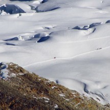 People are coming back from the summit - the last traverse of the glacier 